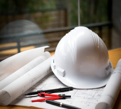 construction-concept-image-helmet-rolled-blueprints-wooden-boards-retro-style